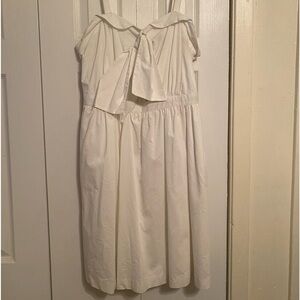 White dress with tie in the front.